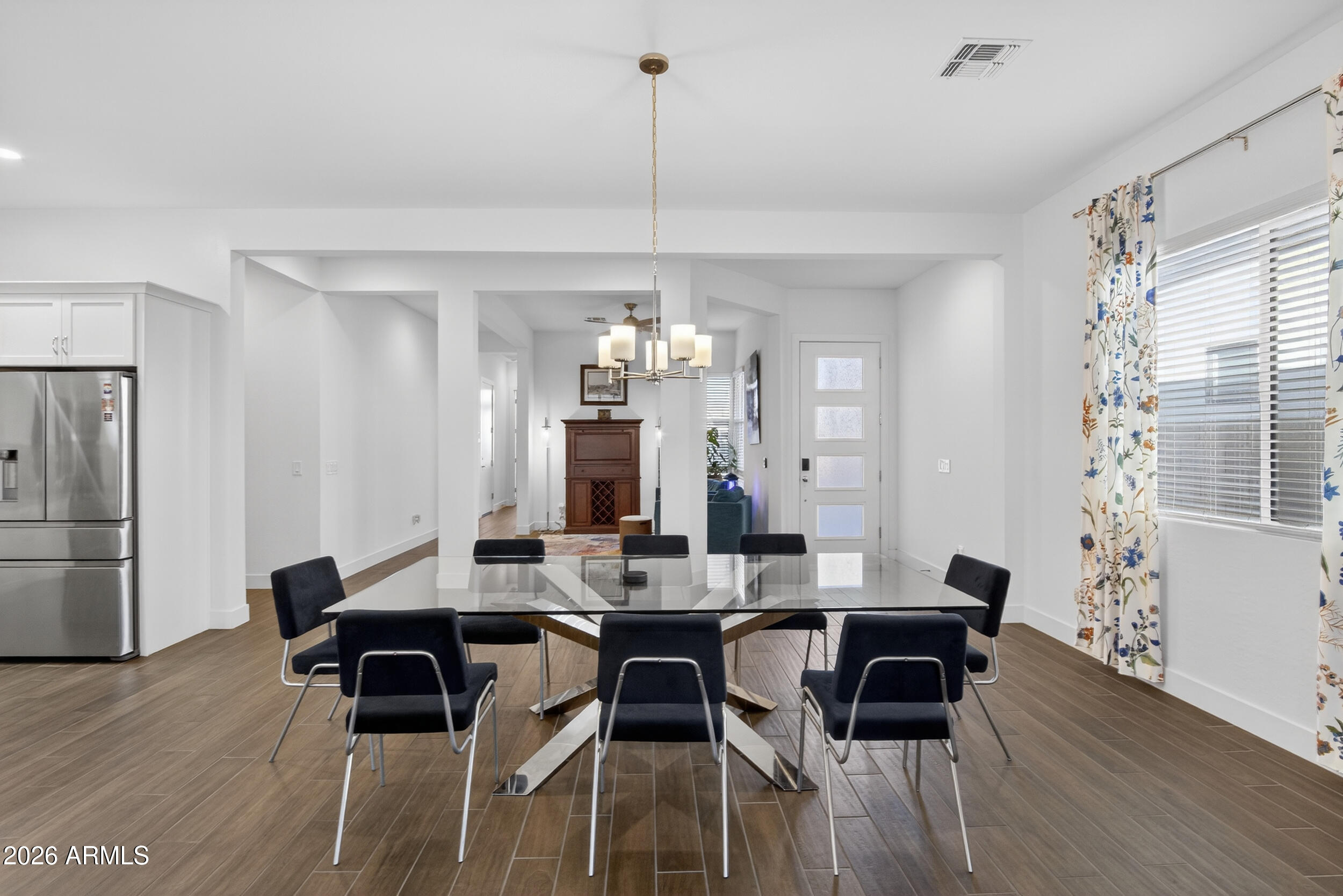 939 East Paseo Way Phoenix, AZ 85042 - Photo 11 of 78 a view of a dining room with furniture window and wooden floor
