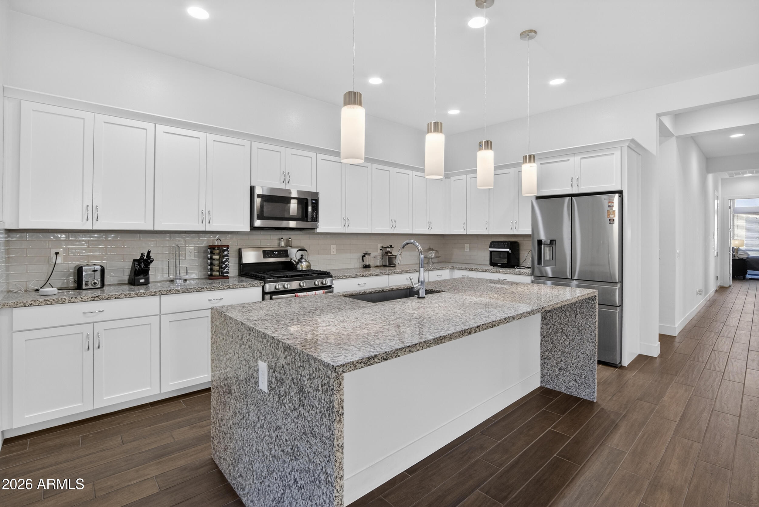 939 East Paseo Way Phoenix, AZ 85042 - Photo 17 of 78 a kitchen with stainless steel appliances granite countertop a sink stove and refrigerator