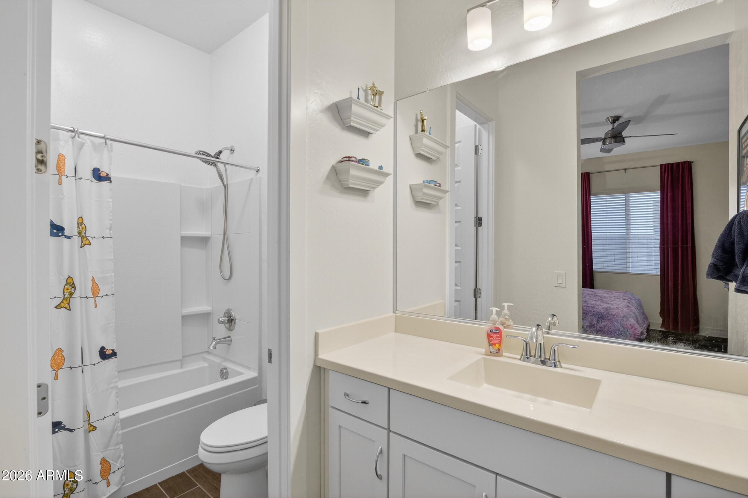 939 East Paseo Way Phoenix, AZ 85042 - Photo 41 of 78 a bathroom with a sink a toilet a mirror a bathtub and shower