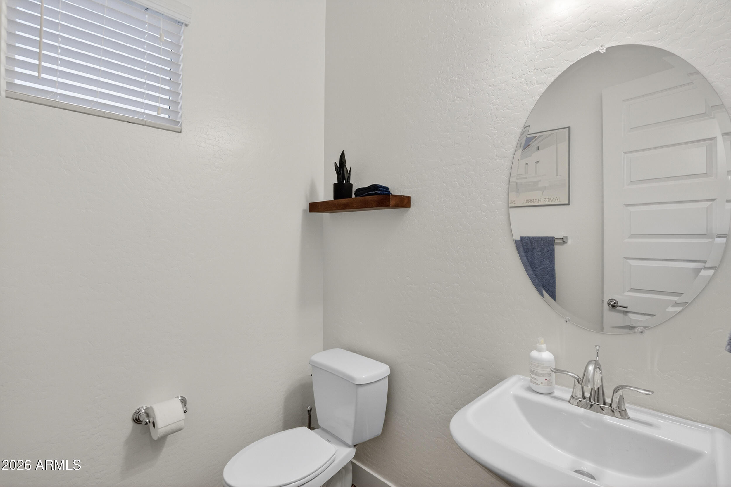 939 East Paseo Way Phoenix, AZ 85042 - Photo 42 of 78 a bathroom with a toilet sink and mirror