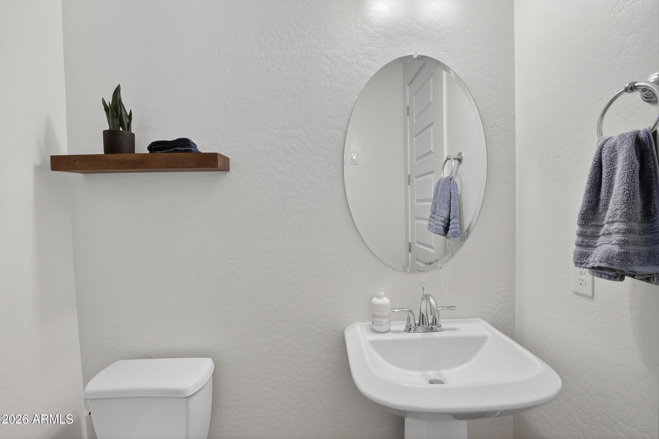 939 East Paseo Way Phoenix, AZ 85042 - Photo 43 of 78 a bathroom with a sink a toilet and a mirror