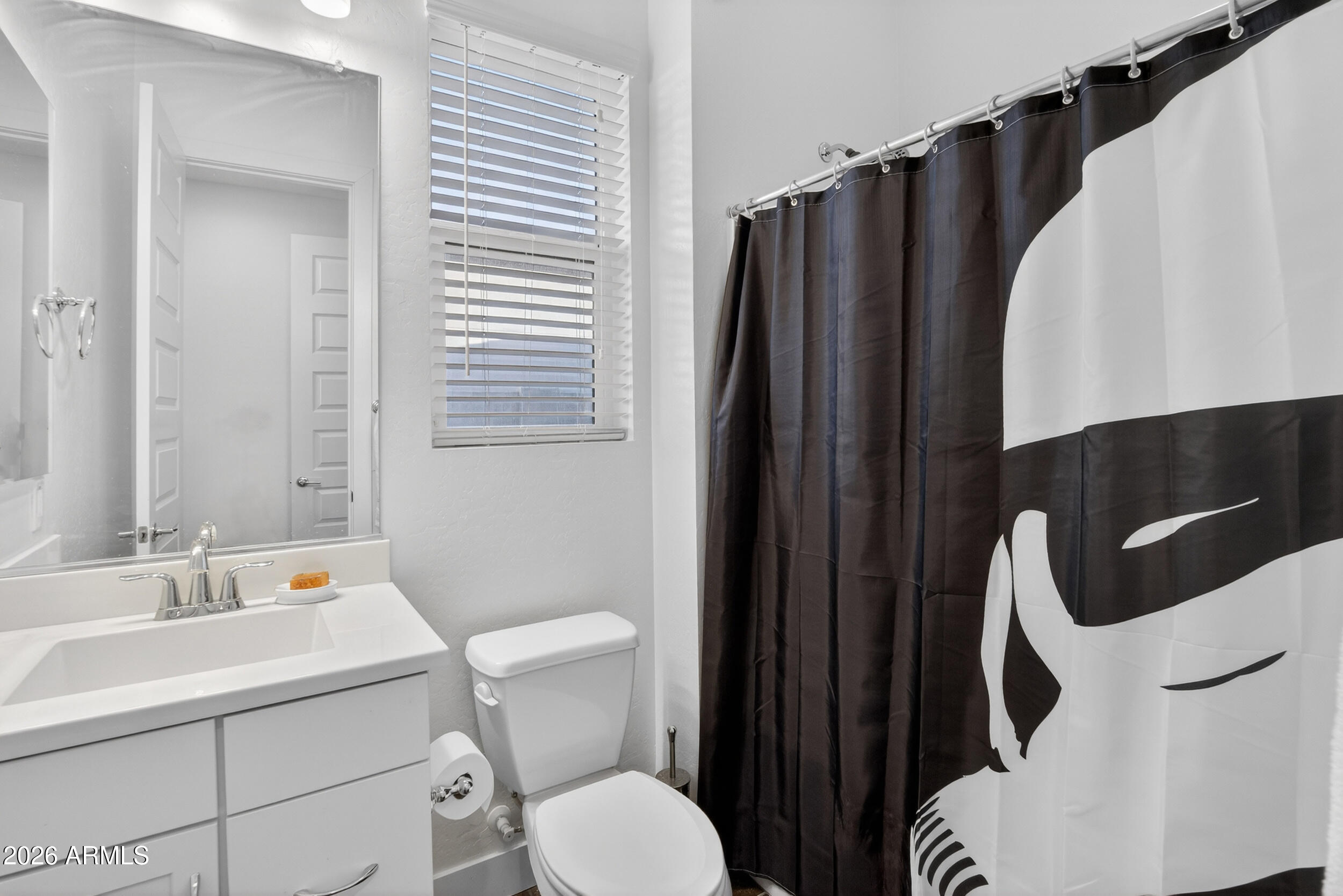 939 East Paseo Way Phoenix, AZ 85042 - Photo 54 of 78 a bathroom with a toilet sink and mirror