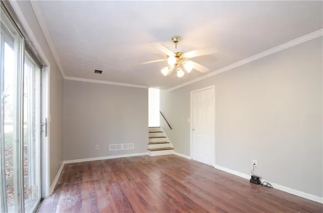 wooden floor in an empty room with a window