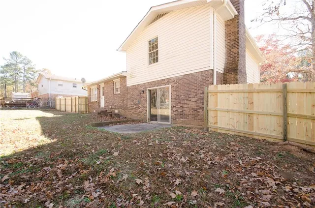 a view of a backyard with large trees