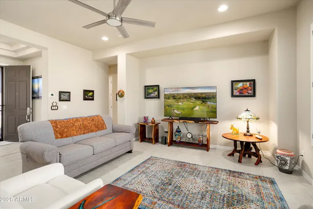 a living room with furniture and kitchen view