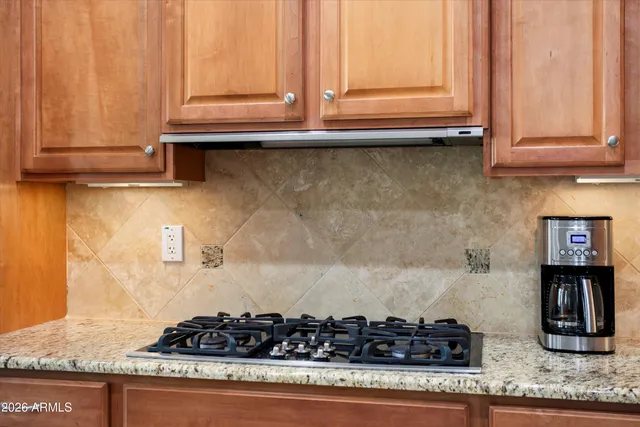 a view of a dining room with furniture a rug and wooden floor