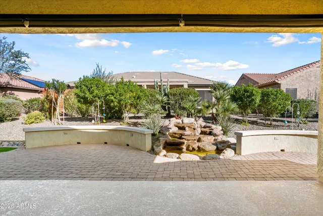 a view of a backyard with a garden and entertaining space