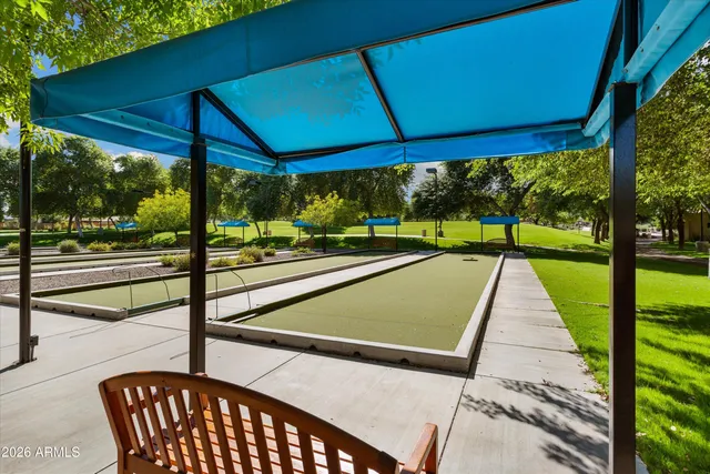 a swimming pool with outdoor seating and yard