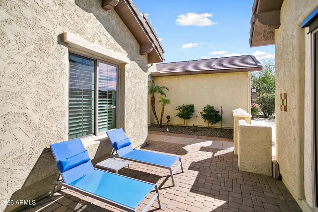 a view of a patio with table and chairs and potted plants