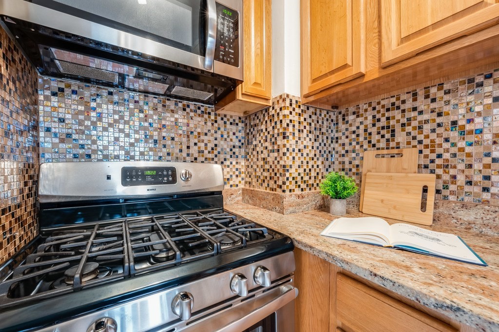 3 Crawford Street, Unit 9 Cambridge, MA 02139 - Photo 15 of 23 a stove top oven sitting inside of a kitchen