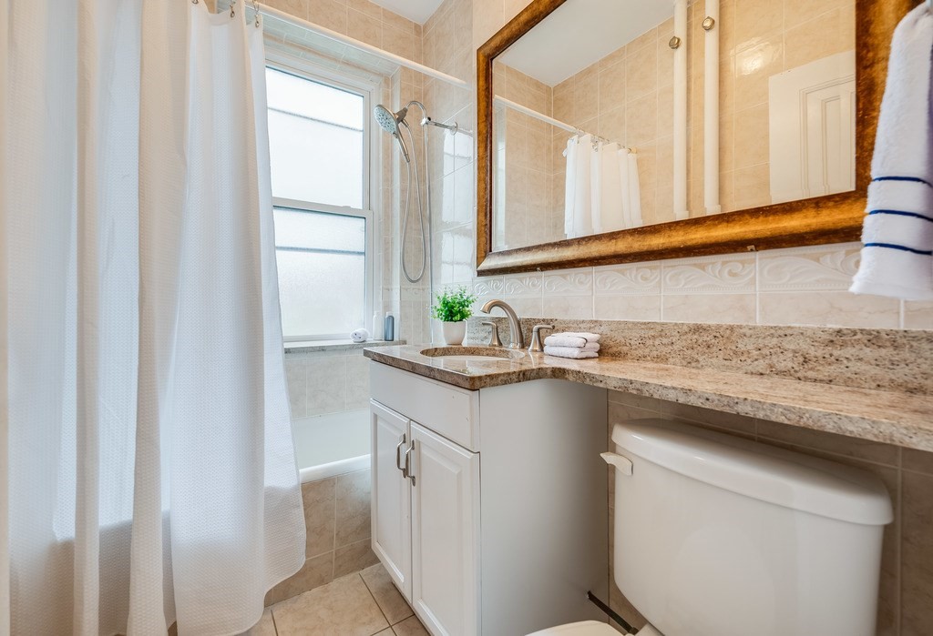 3 Crawford Street, Unit 9 Cambridge, MA 02139 - Photo 18 of 23 a kitchen with granite countertop a sink and a window