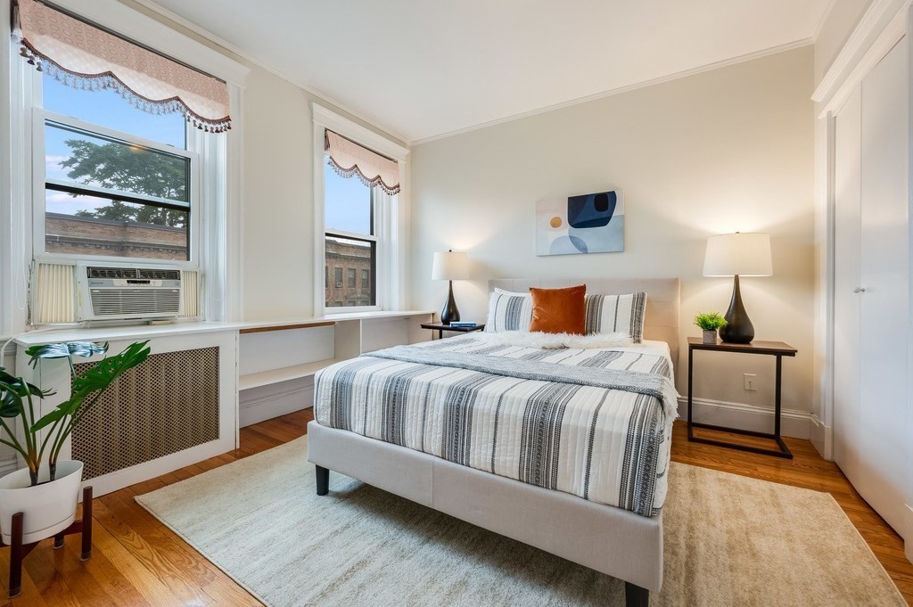 3 Crawford Street, Unit 9 Cambridge, MA 02139 - Photo 21 of 23 a bedroom with a large bed and a wooden floor