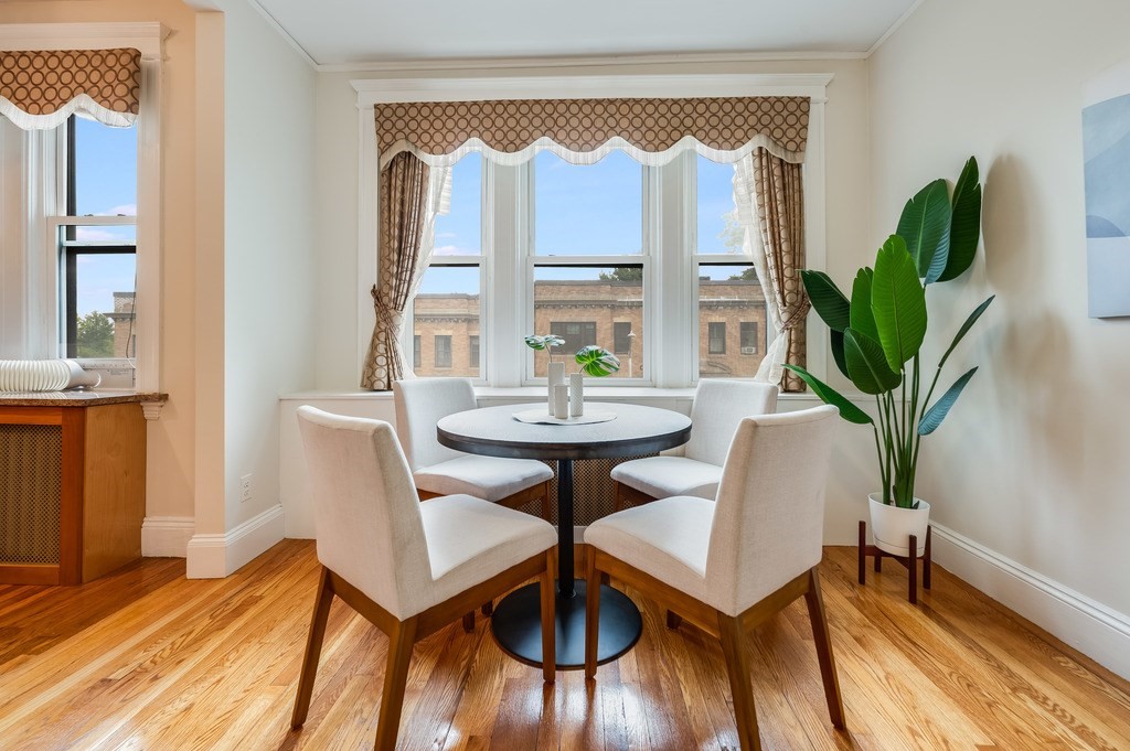 3 Crawford Street, Unit 9 Cambridge, MA 02139 - Photo 9 of 23 a view of a dining room with furniture window and wooden floor