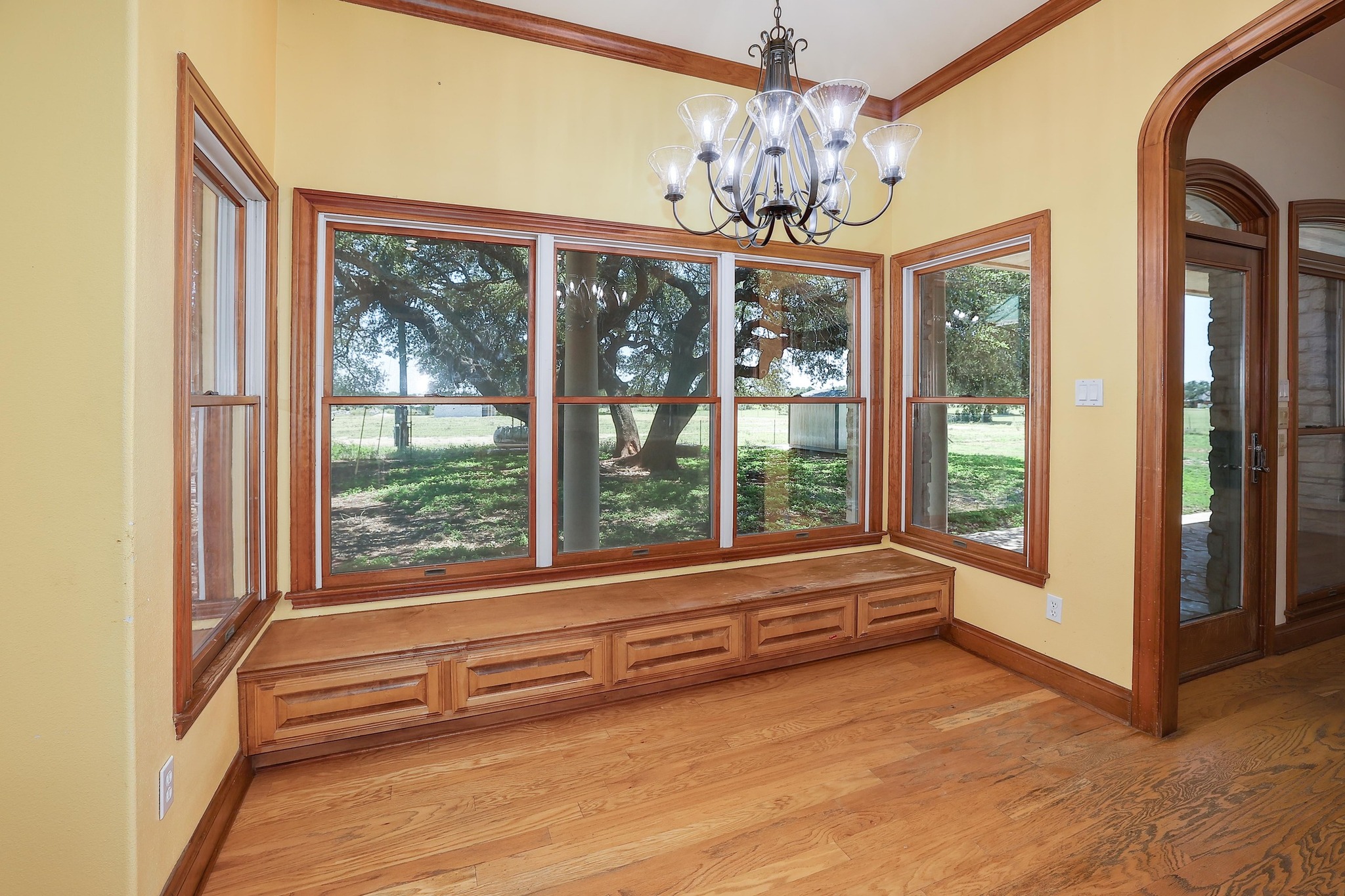 3900 Shell Road Georgetown, TX 78628 - Photo 8 of 40 Unfurnished dining area featuring a chandelier, light wood-type flooring, and crown molding
