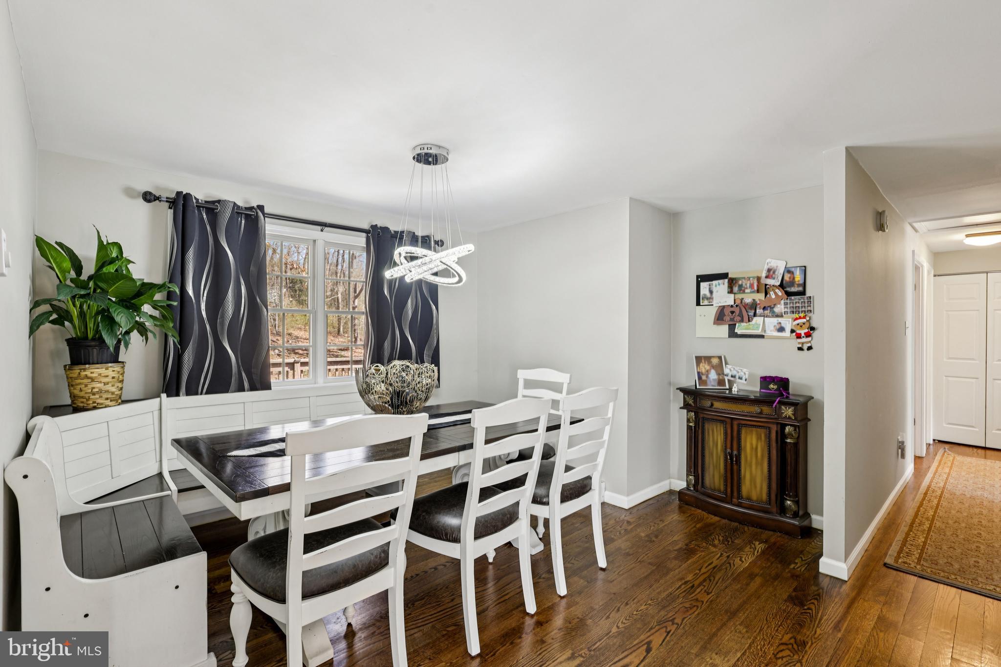 78 Rising Sun Tavern Road Millstone Township, NJ 08510 - Photo 13 of 55 a view of a dining room with furniture and wooden floor