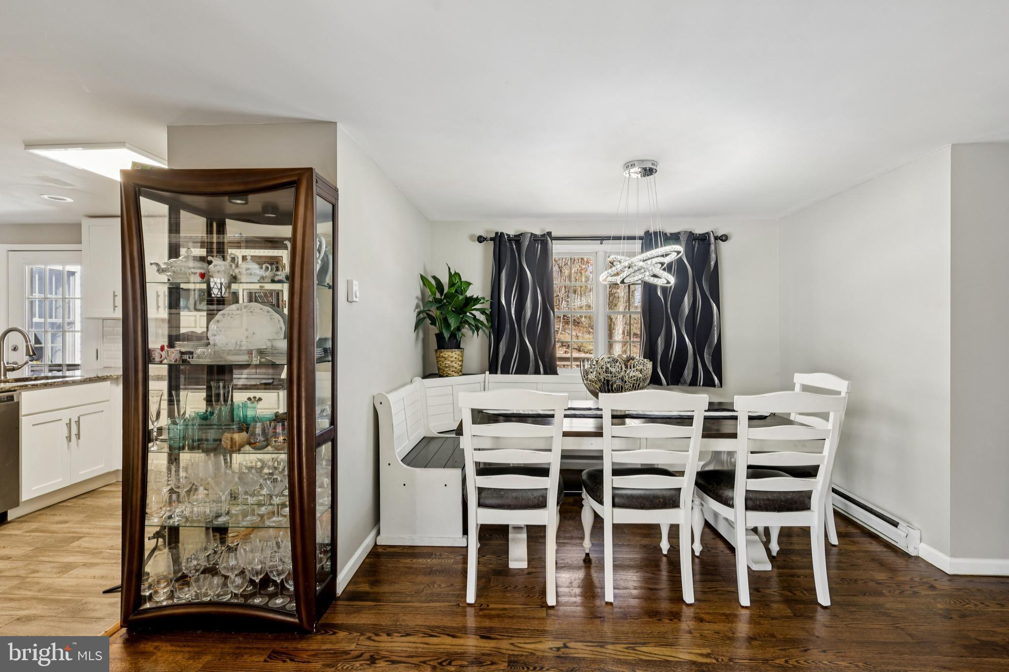78 Rising Sun Tavern Road Millstone Township, NJ 08510 - Photo 14 of 55 a dining room with furniture wooden floor and a floor to ceiling window