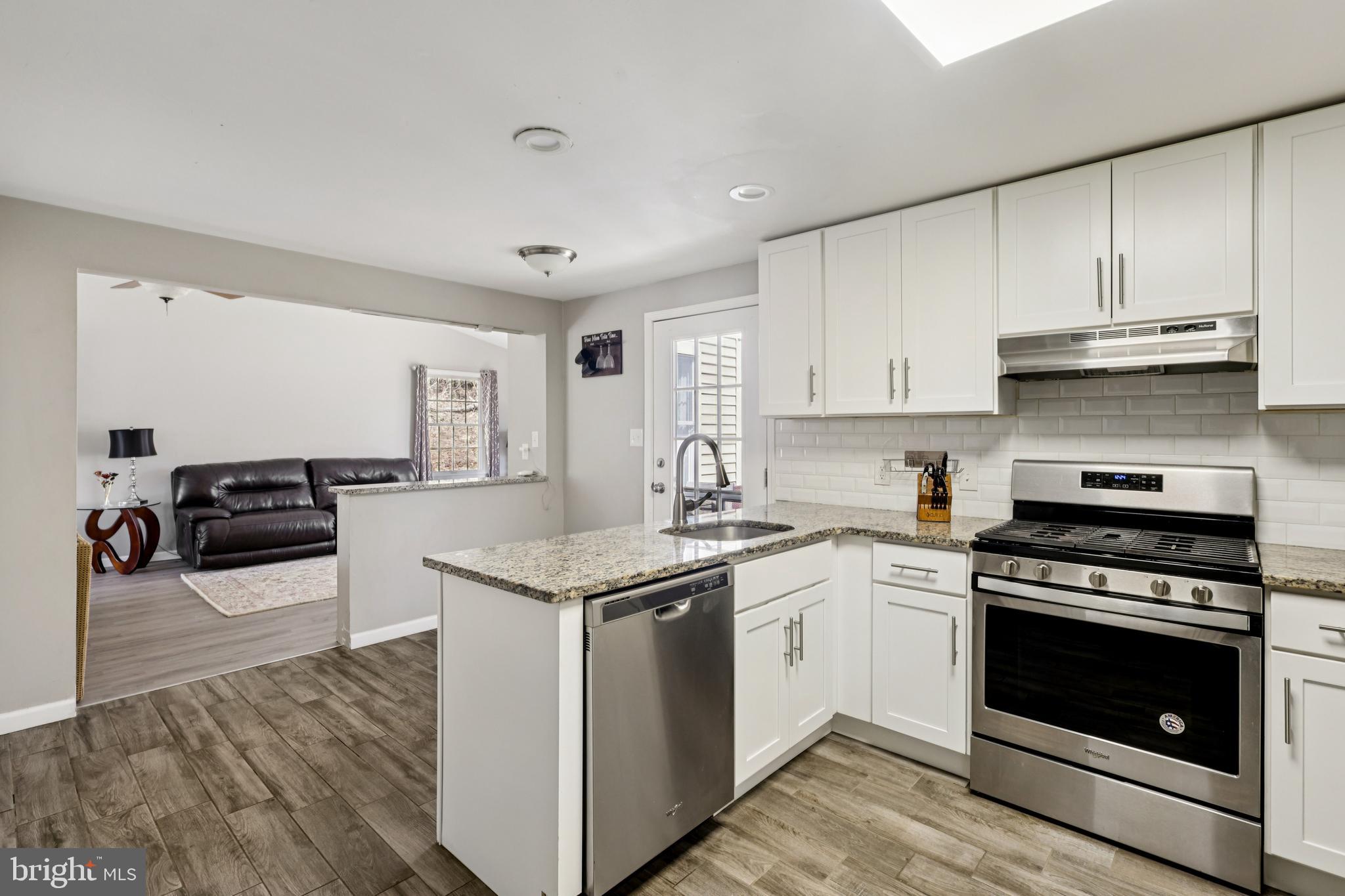 78 Rising Sun Tavern Road Millstone Township, NJ 08510 - Photo 19 of 55 a kitchen with granite countertop white cabinets and white appliances