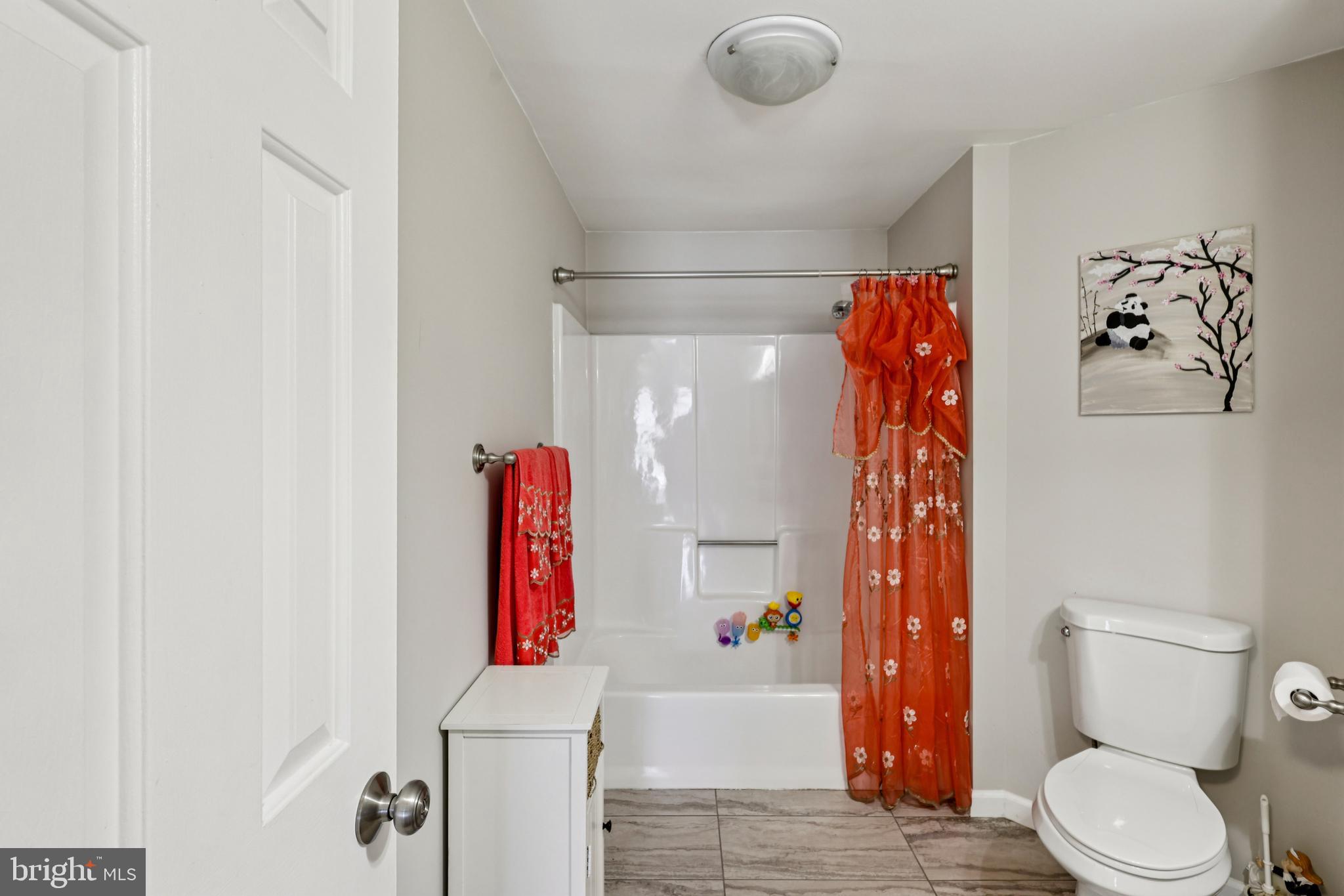 78 Rising Sun Tavern Road Millstone Township, NJ 08510 - Photo 34 of 55 a bathroom with a toilet and a shower curtain