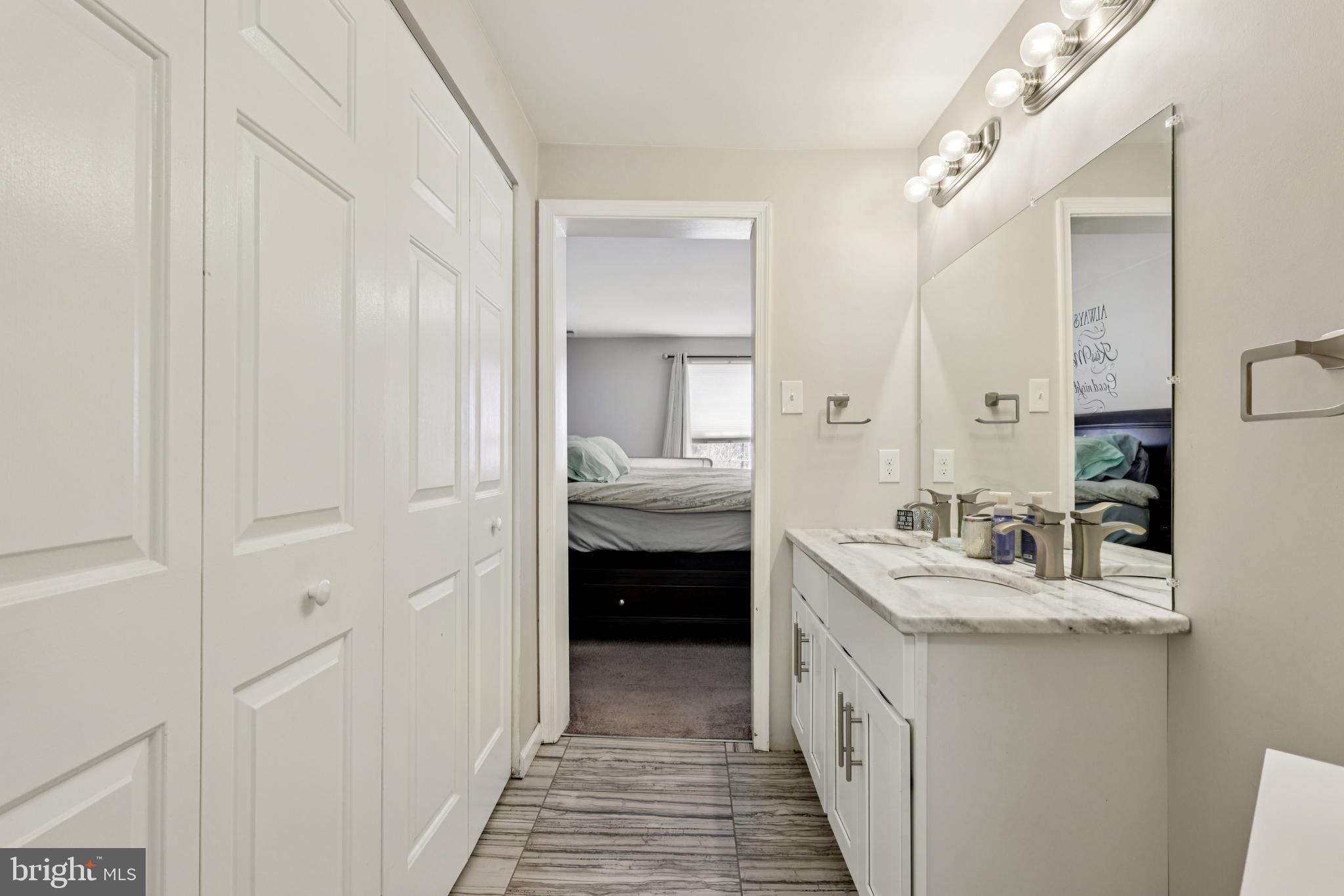 78 Rising Sun Tavern Road Millstone Township, NJ 08510 - Photo 38 of 55 a bathroom with a double vanity sink and a mirror