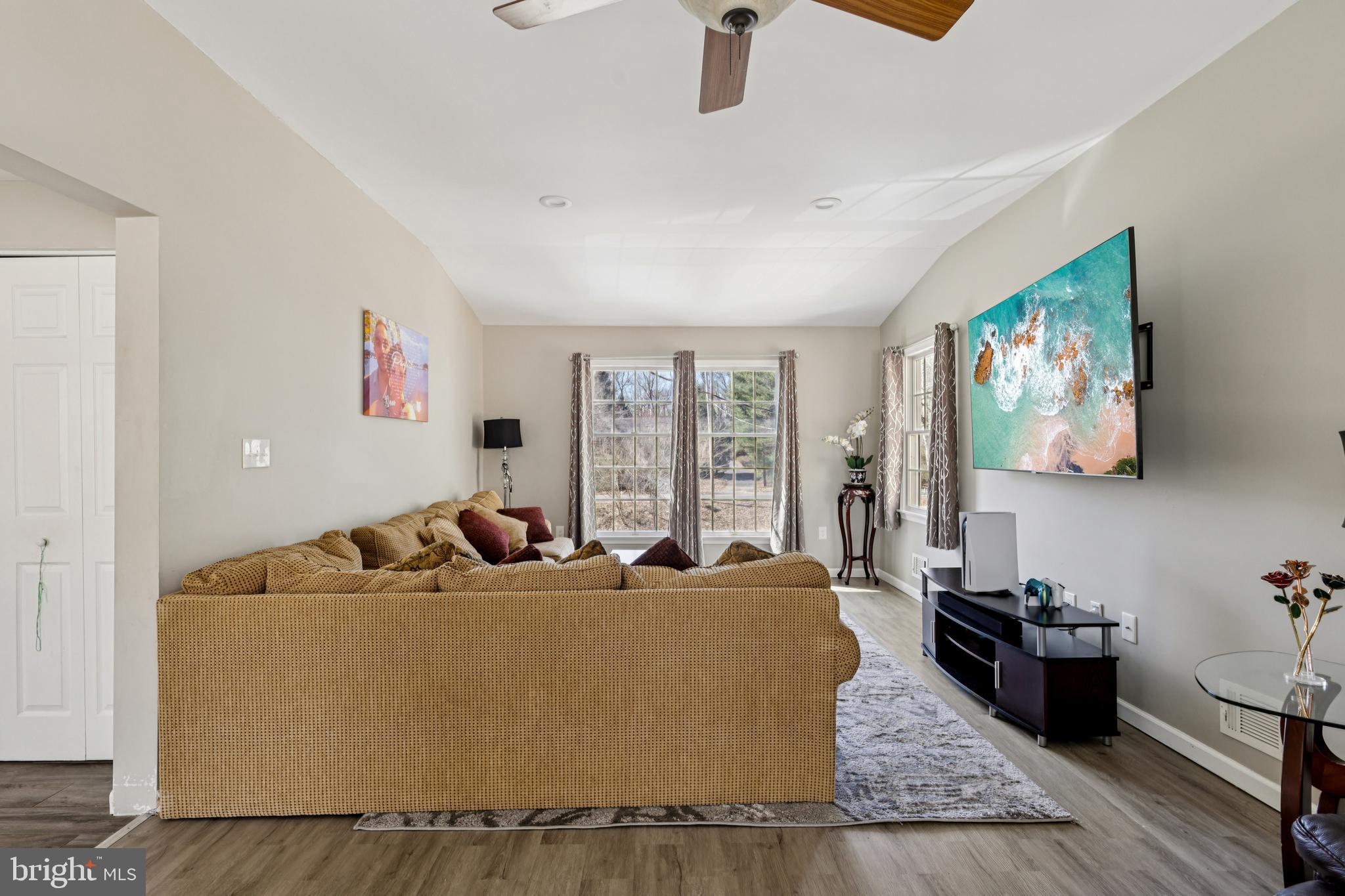 78 Rising Sun Tavern Road Millstone Township, NJ 08510 - Photo 10 of 55 a living room with furniture and a flat screen tv