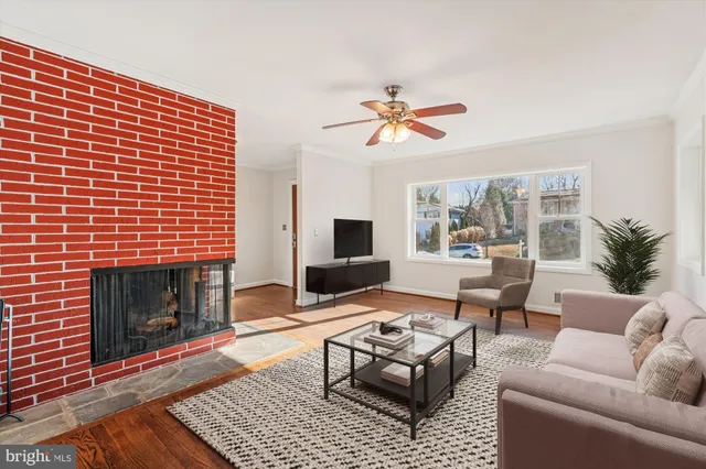 a view of an empty room with window and a chandelier fan