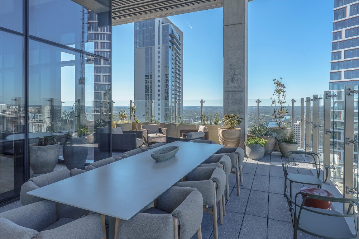 610 Davis Street, Unit 4708 Austin, TX 78701 - Photo 8 of 29 a dining room with furniture and a floor to ceiling window