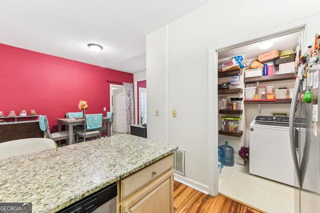 a kitchen with stainless steel appliances granite countertop a sink and a refrigerator