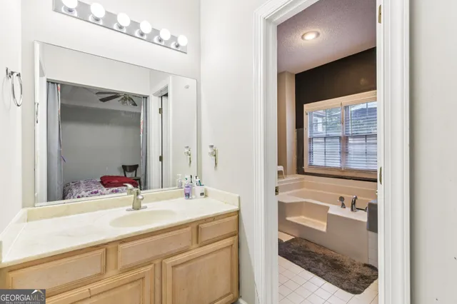a en suite bathroom with a sink a mirror and a shower