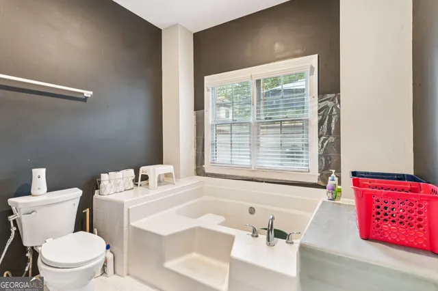 a bathroom with a sink a toilet and a bathtub