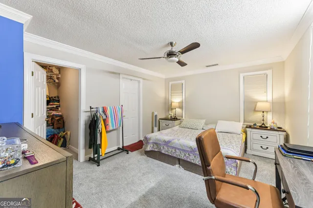 a bed room with a bed mirror and a window