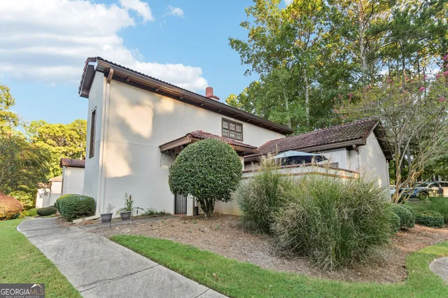 a front view of a house with garden