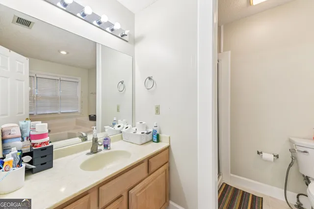 a bathroom with a sink double vanity and a mirror