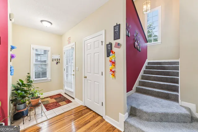 a view of entryway with furniture and wooden floor