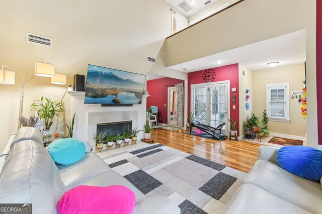 a living room with furniture potted plant and a fireplace