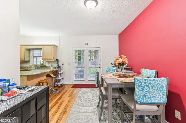 a view of a dining room with furniture and a kitchen
