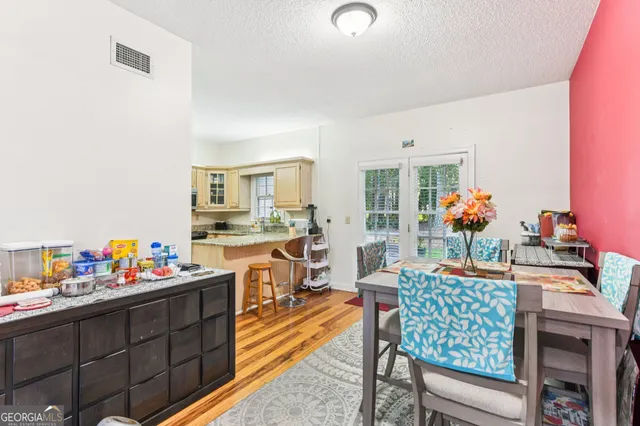 a dining room filled with furniture and wooden floor