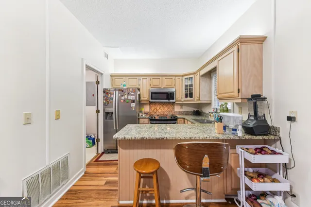 a large kitchen with granite countertop lots of counter top space