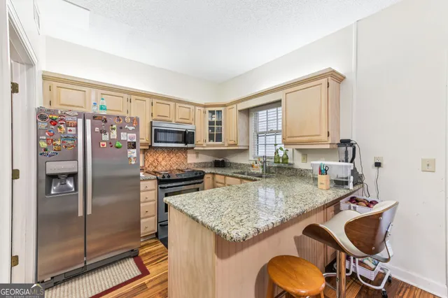 a kitchen with a refrigerator a stove a sink and dishwasher