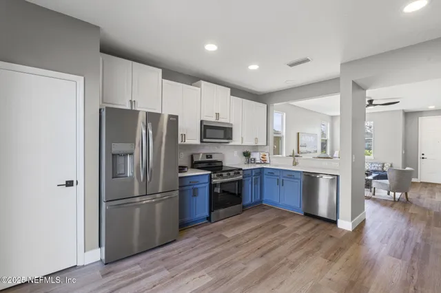 a bathroom with a double vanity sink toilet mirror and bathtub