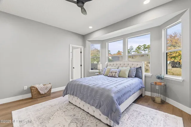 a kitchen with granite countertop a sink cabinets and wooden floor