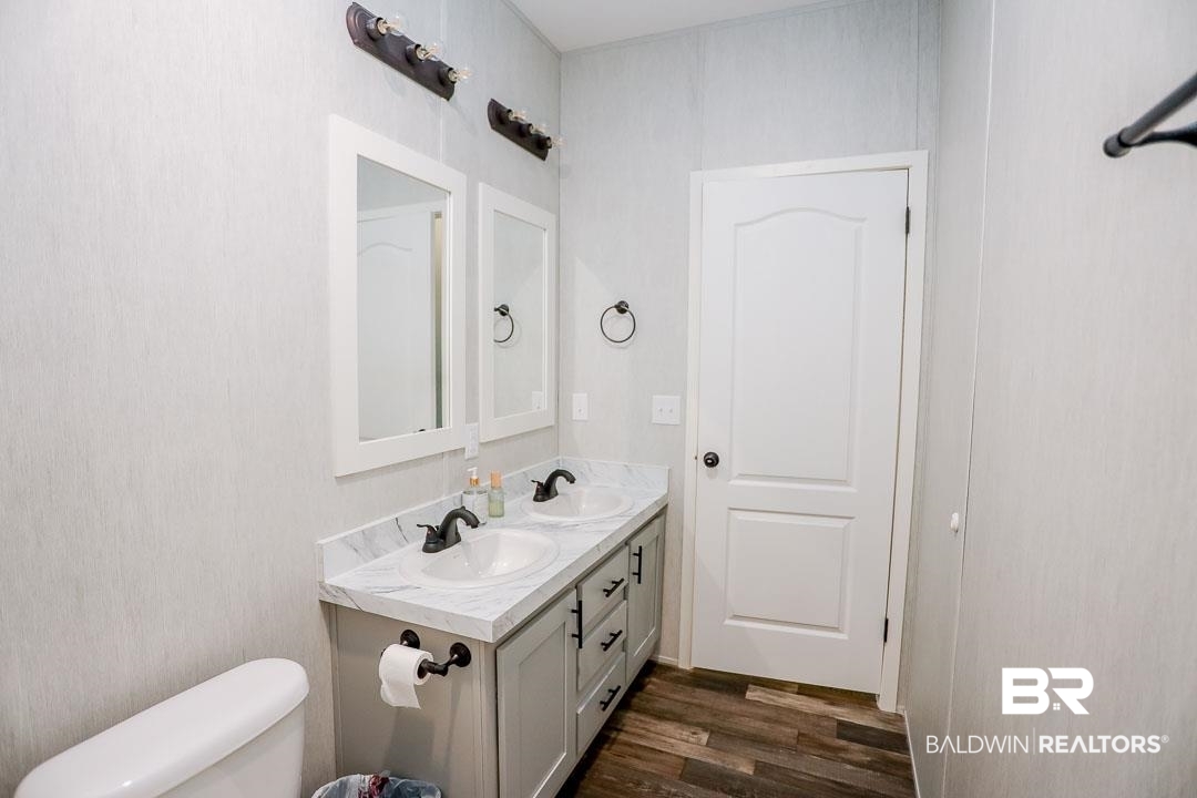 19180 Horseshoe Circle Seminole, AL 36574 - Photo 18 of 38 Bathroom with double vanity and dark wood finished floors