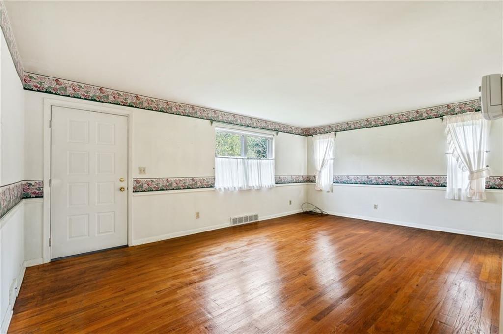 1268 Old State Road Apollo, PA 15613 - Photo 16 of 22 a view of an empty room with wooden floor and a window