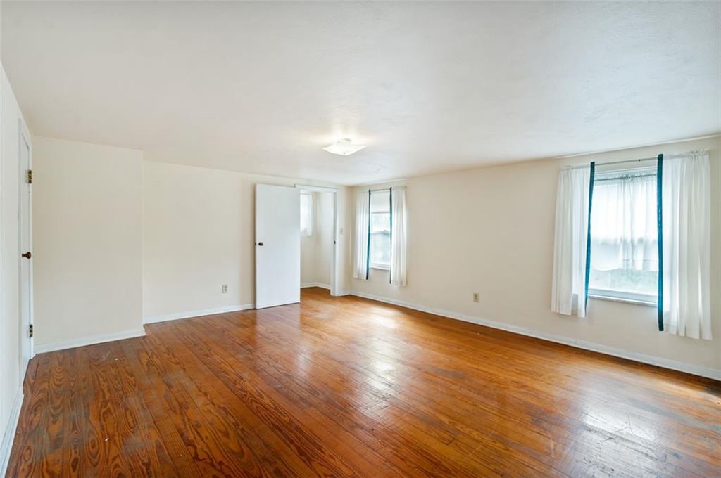 1268 Old State Road Apollo, PA 15613 - Photo 9 of 22 an empty room with wooden floor and windows