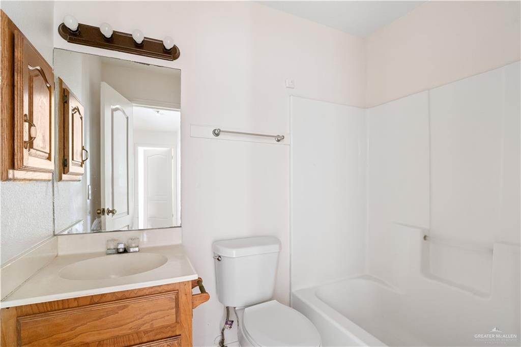 4006 Inspiration Road, Unit 2 Mission, TX 78573 - Photo 12 of 15 a bathroom with a granite countertop sink and a bathtub