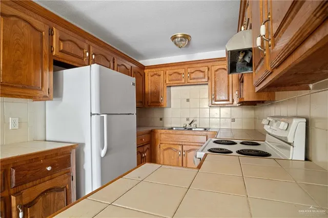 a kitchen with stainless steel appliances a refrigerator and a stove