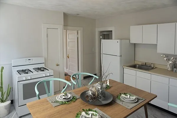 a kitchen with a table chairs stove and cabinets