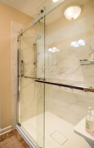 a bathroom with a granite countertop double vanity sink and mirror