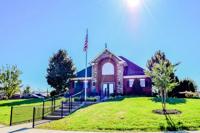 a front view of a house with garden