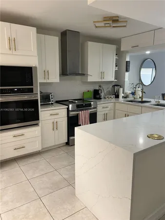 a kitchen with a sink window and cabinets