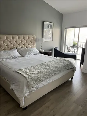 a large bed sitting in a bedroom next to a window
